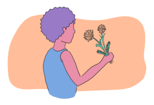 An orange background with a person from the waist up with short curly purple hair, wearing a blue top, holding 2 flowers in their right hand.