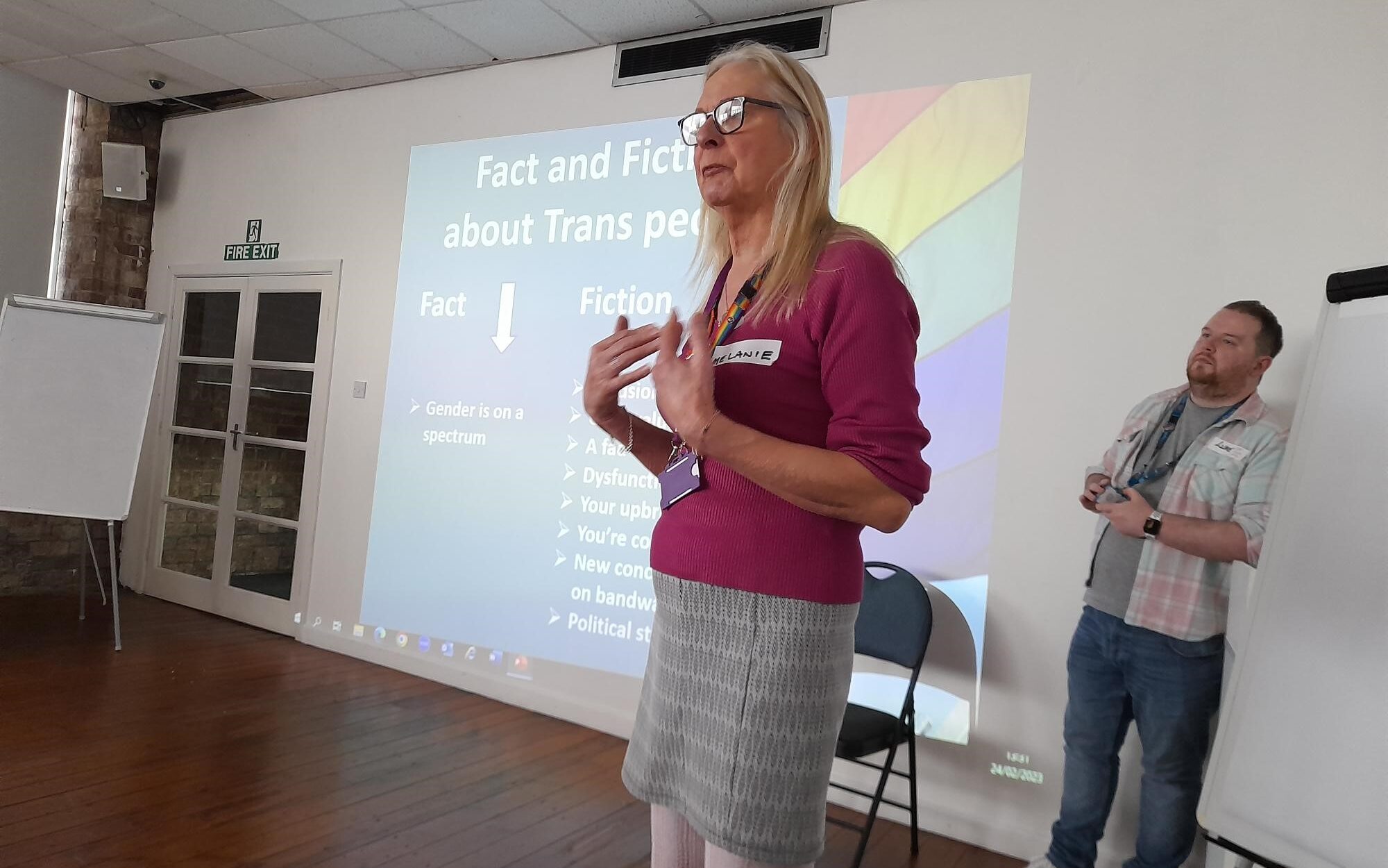 Guest speaker, Melanie Hardwick, presenting a slide titled 'Fact and Fiction about Trans people'. 