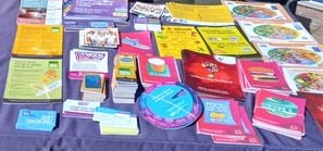 Selection of colourful leaflets on a purple background, including mental health, eating well, drink and alcohol support, quit smoking and lots more. Just a sample of the sorts of what could be available from PHRC.