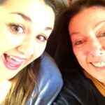 Selfie of Lily and Kate with their heads together. Both have light skin tones, long dark hair and are grinning happily at the camera.