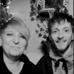 Black and white photo of Trudi and Benjamin, both have light skin tones, short hair and are smiling at the camera.